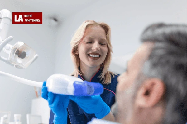 Dentist performing lazer whitening on a patient to remove extrinsic stains Borehamwood