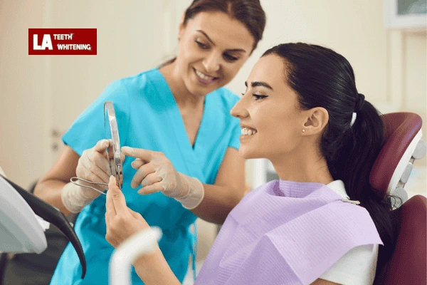A dentist providing aftercare instructions for maintaining lazer teeth whitening results Borehamwood